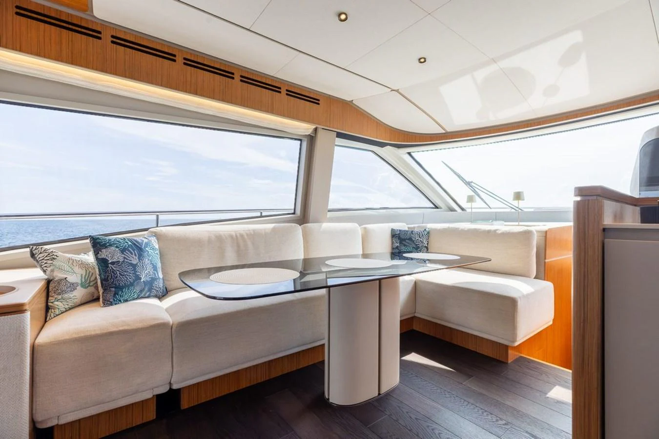 The salon features a spacious seating area with large windows offering panoramic views. aboard 2025 FERRETTI 670 KATRIN I Yacht for Sale