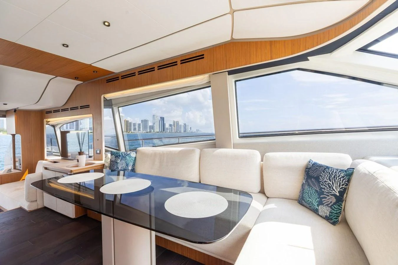 The salon offers a spacious and bright seating area with panoramic windows and modern decor. aboard 2025 FERRETTI 670 KATRIN I Yacht for Sale