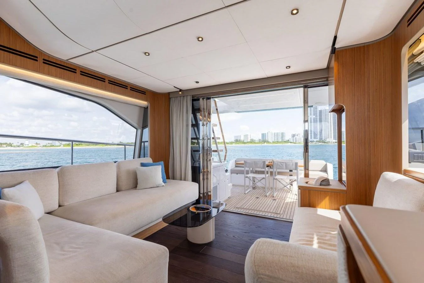 The salon offers a spacious and elegant seating area with a view of the water through large windows. aboard 2025 FERRETTI 670 KATRIN I Yacht for Sale