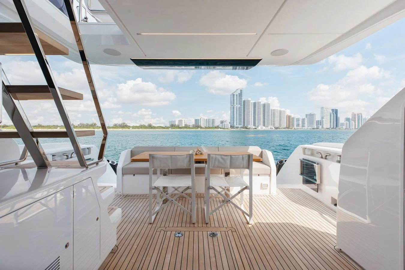 The aft deck offers a spacious and inviting area with a stunning view of the city skyline. aboard 2025 FERRETTI 670 KATRIN I Yacht for Sale