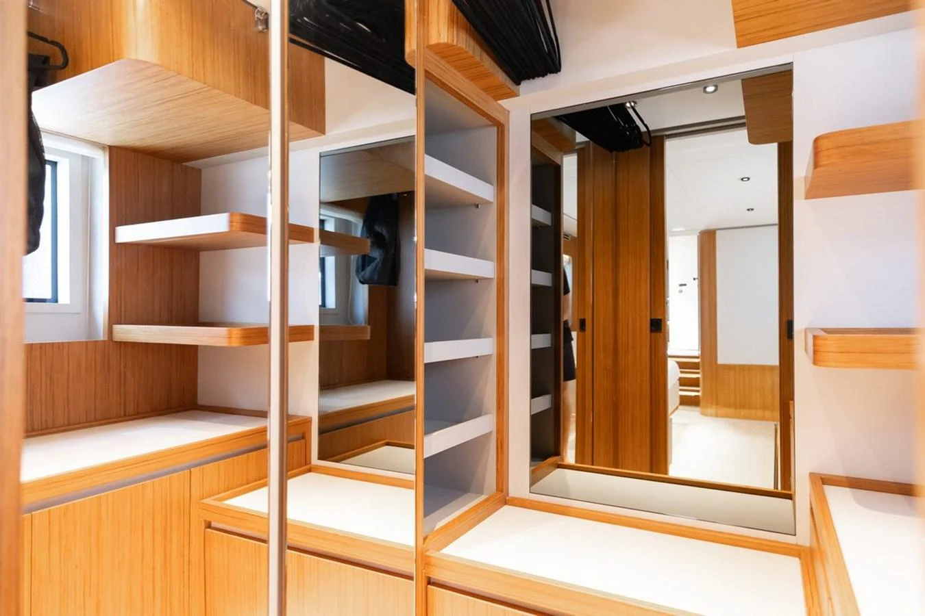 The yacht's interior features a modern and spacious dressing area with ample storage and mirrors. aboard 2025 FERRETTI 670 KATRIN I Yacht for Sale