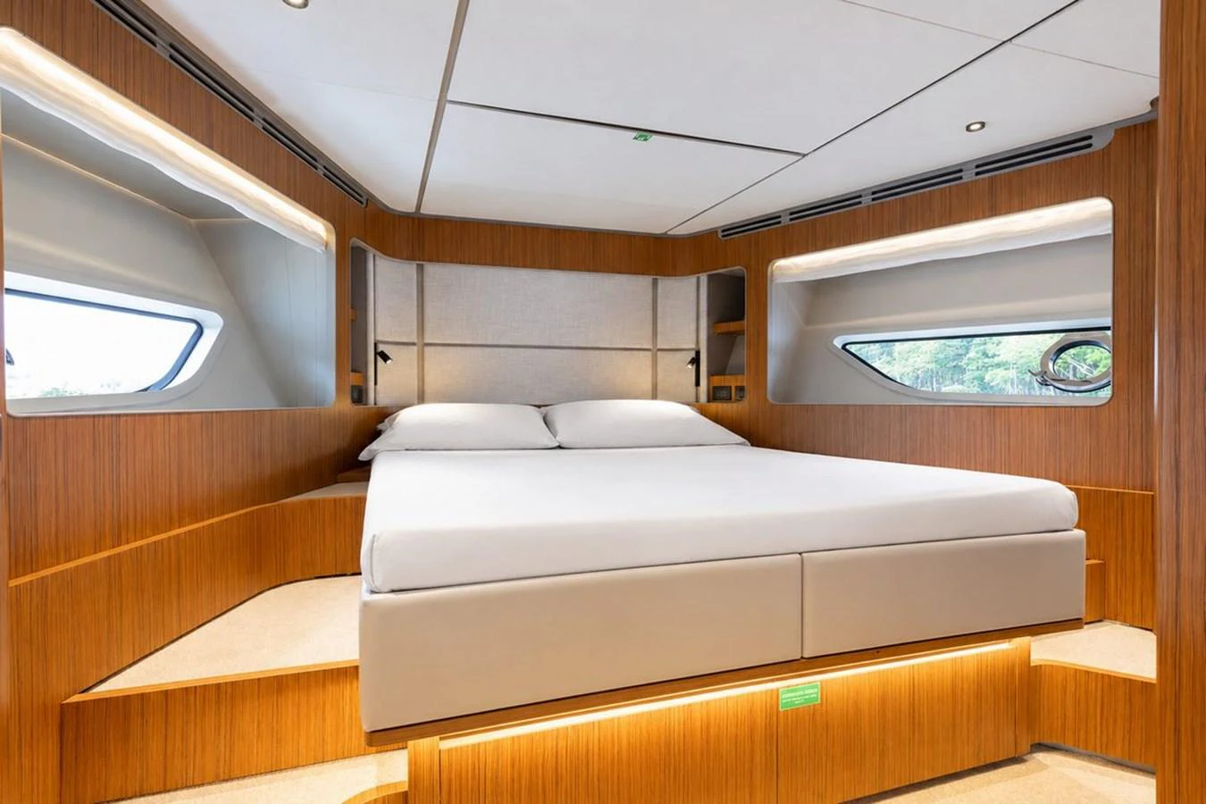 The stateroom features a luxurious bed with ample natural light from the surrounding windows. aboard 2025 FERRETTI 670 KATRIN I Yacht for Sale