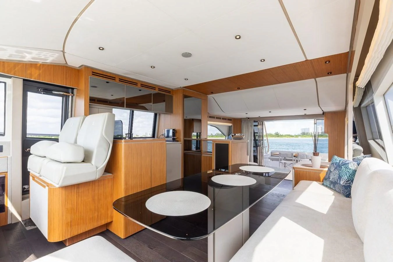 The yacht's salon features a spacious and modern design with ample seating and large windows for natural light. aboard 2025 FERRETTI 670 KATRIN I Yacht for Sale