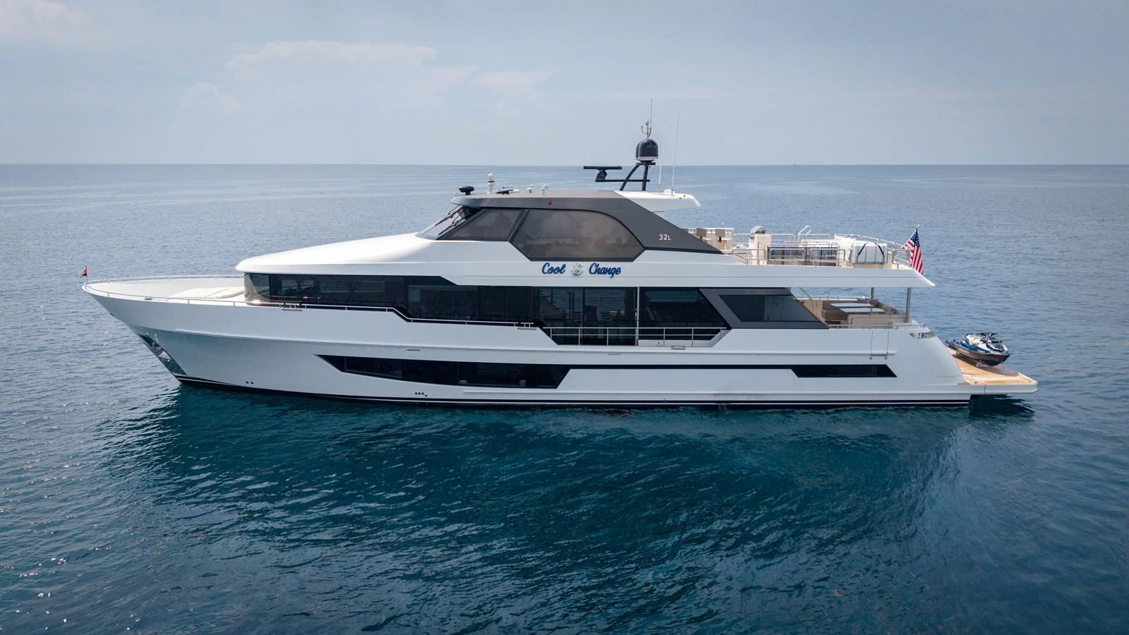 A sleek and modern yacht cruising on calm waters under a clear sky. aboard COOL CHANGE Yacht for Sale