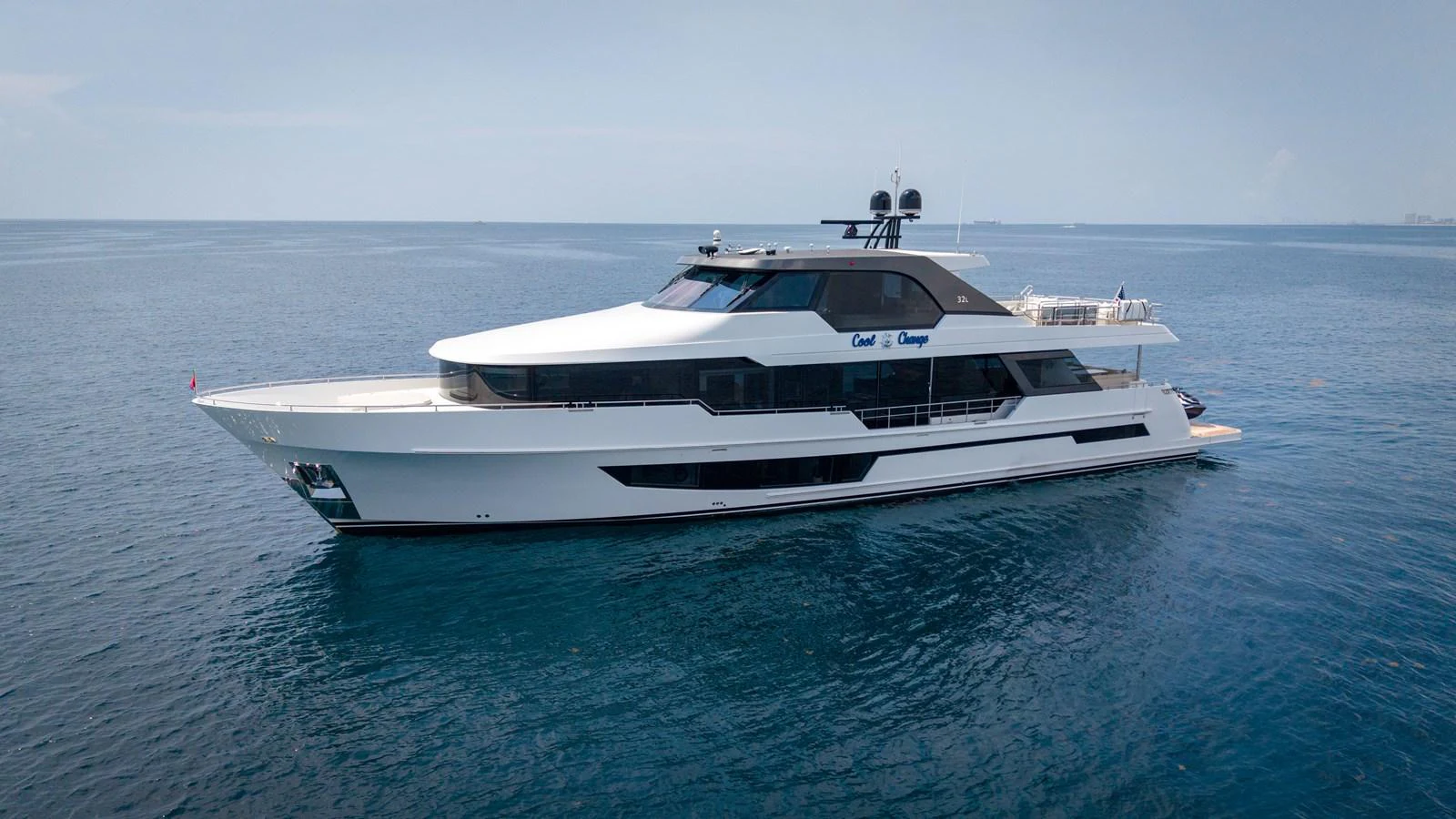 A sleek and modern yacht glides gracefully on calm blue waters. aboard COOL CHANGE Yacht for Sale