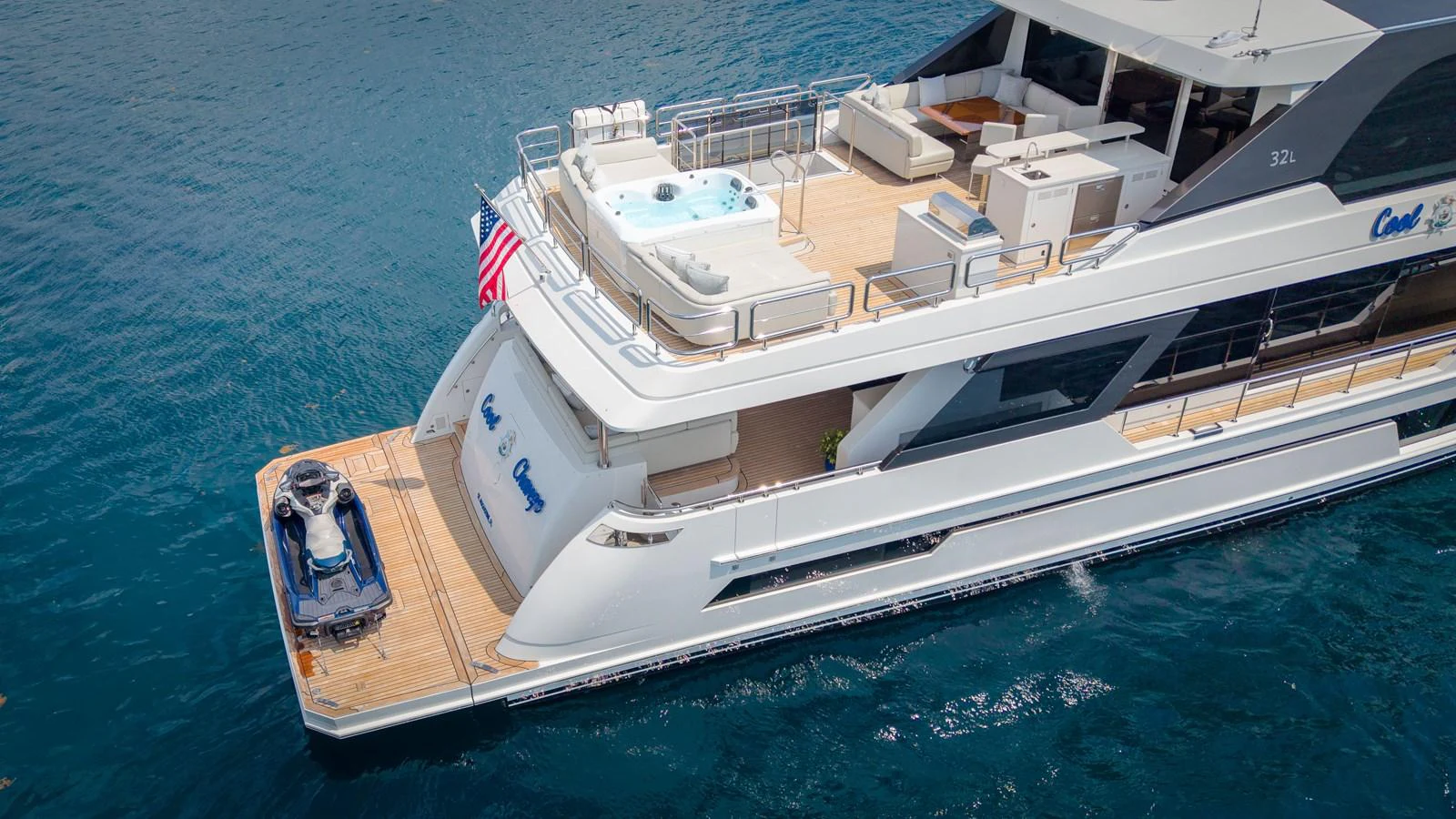 The yacht's aft deck features a spacious layout with a jacuzzi and a jet ski, perfect for luxurious relaxation and adventure. aboard COOL CHANGE Yacht for Sale