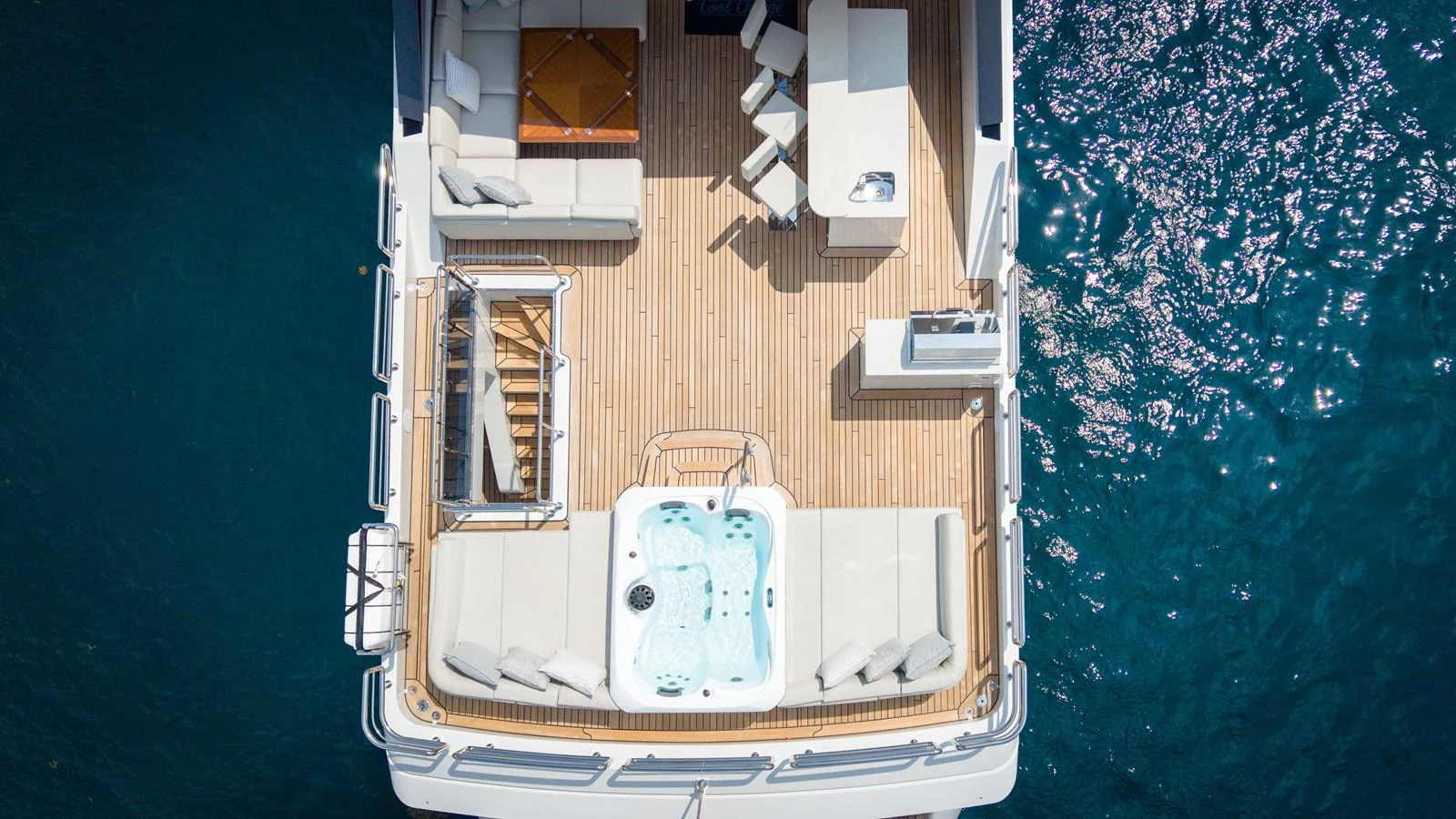 The aft deck features a luxurious hot tub and ample seating for relaxation. aboard COOL CHANGE Yacht for Sale