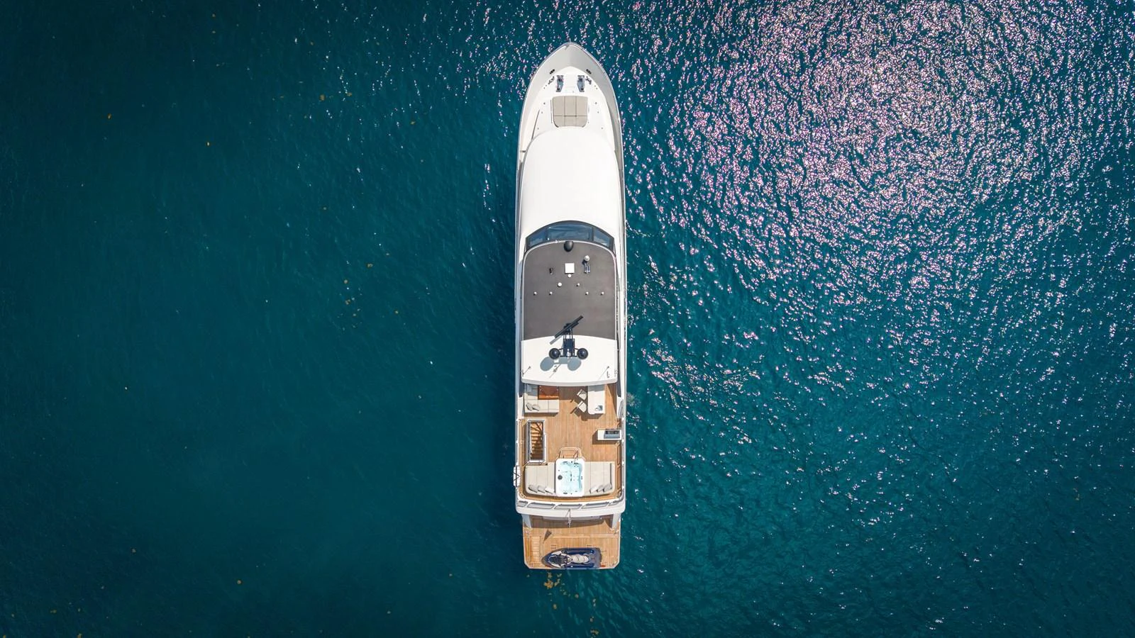 Aerial view of a luxurious yacht cruising on clear blue waters. aboard COOL CHANGE Yacht for Sale