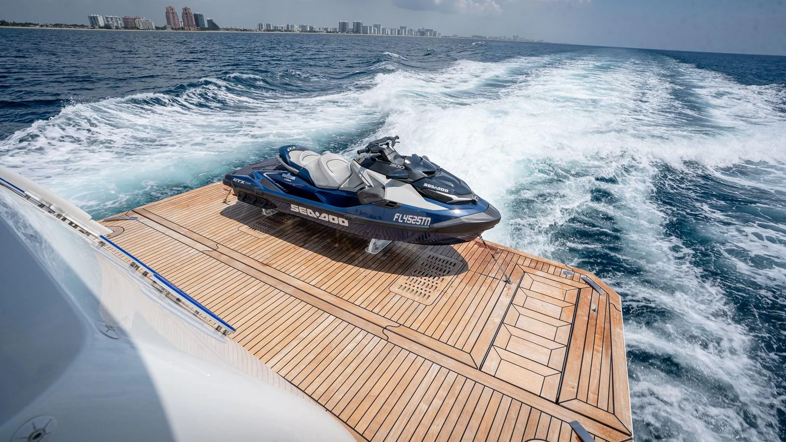 A sleek jet ski is positioned on the yacht's expansive swim platform, ready for adventure. aboard COOL CHANGE Yacht for Sale
