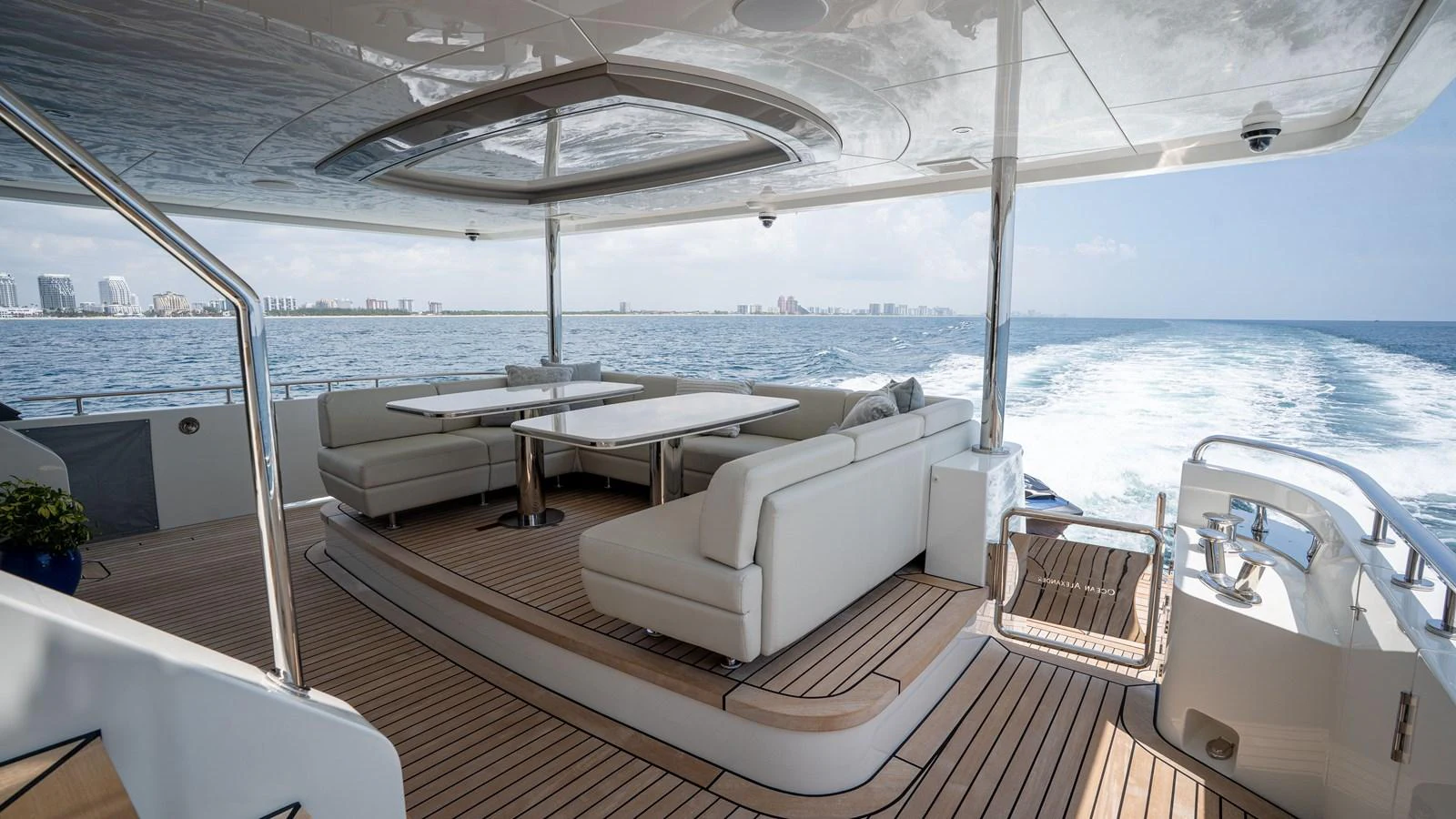 The aft deck features luxurious seating and dining areas with a stunning view of the open sea. aboard COOL CHANGE Yacht for Sale