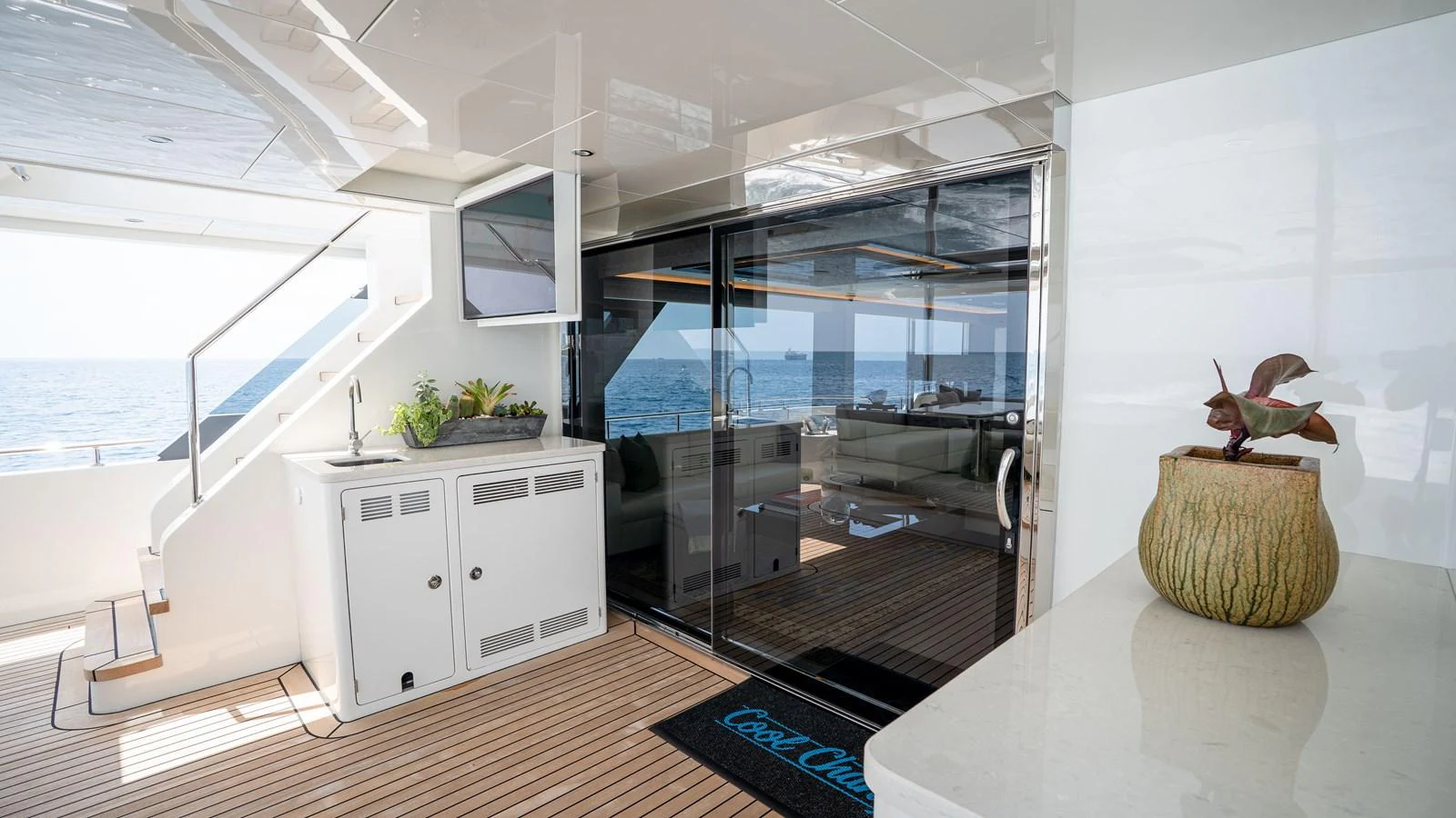 The aft deck offers a seamless transition from the interior to the exterior, featuring a stylish seating area and modern amenities. aboard COOL CHANGE Yacht for Sale