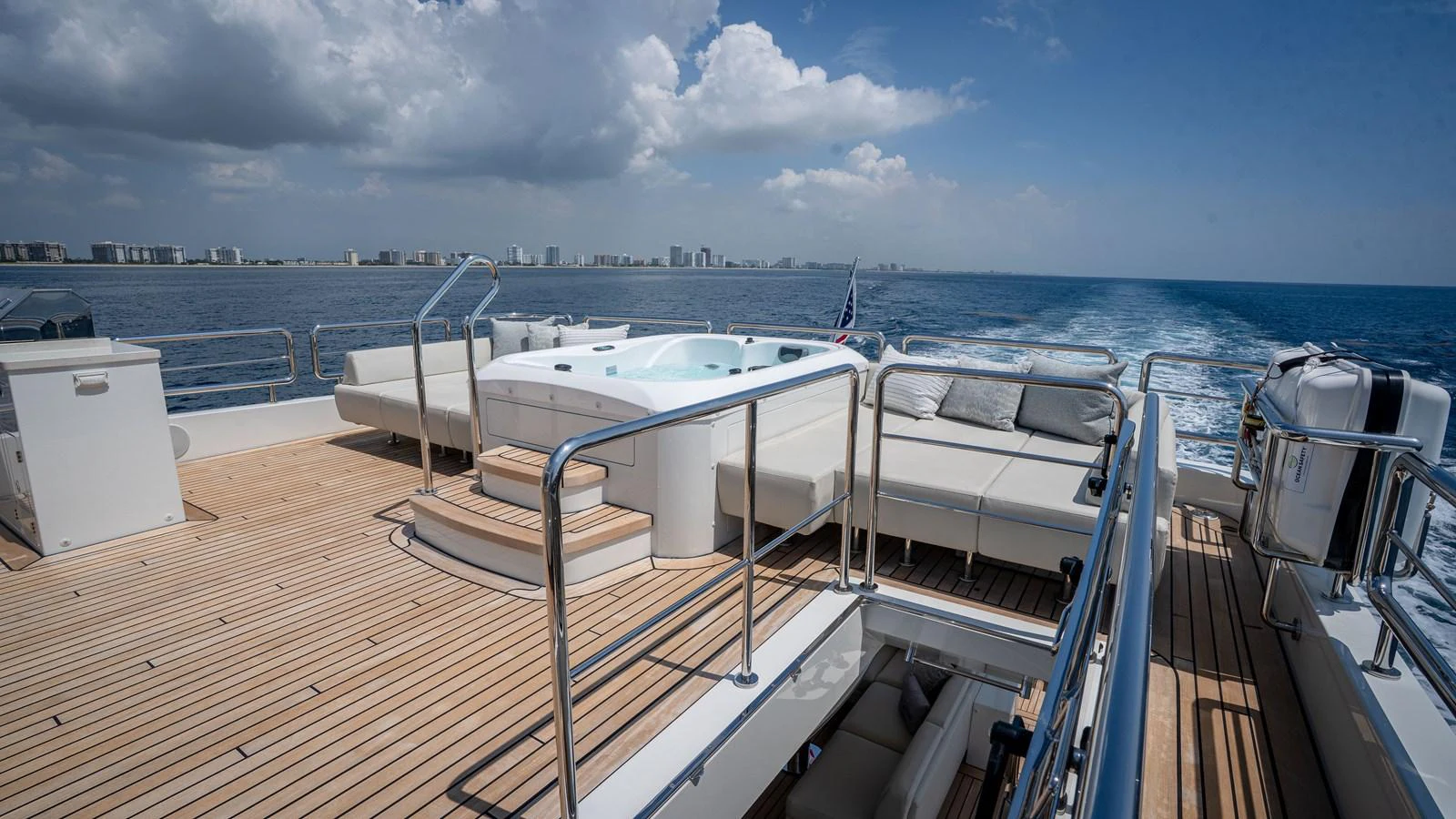 The sundeck features a luxurious hot tub surrounded by comfortable seating, perfect for relaxation. aboard COOL CHANGE Yacht for Sale