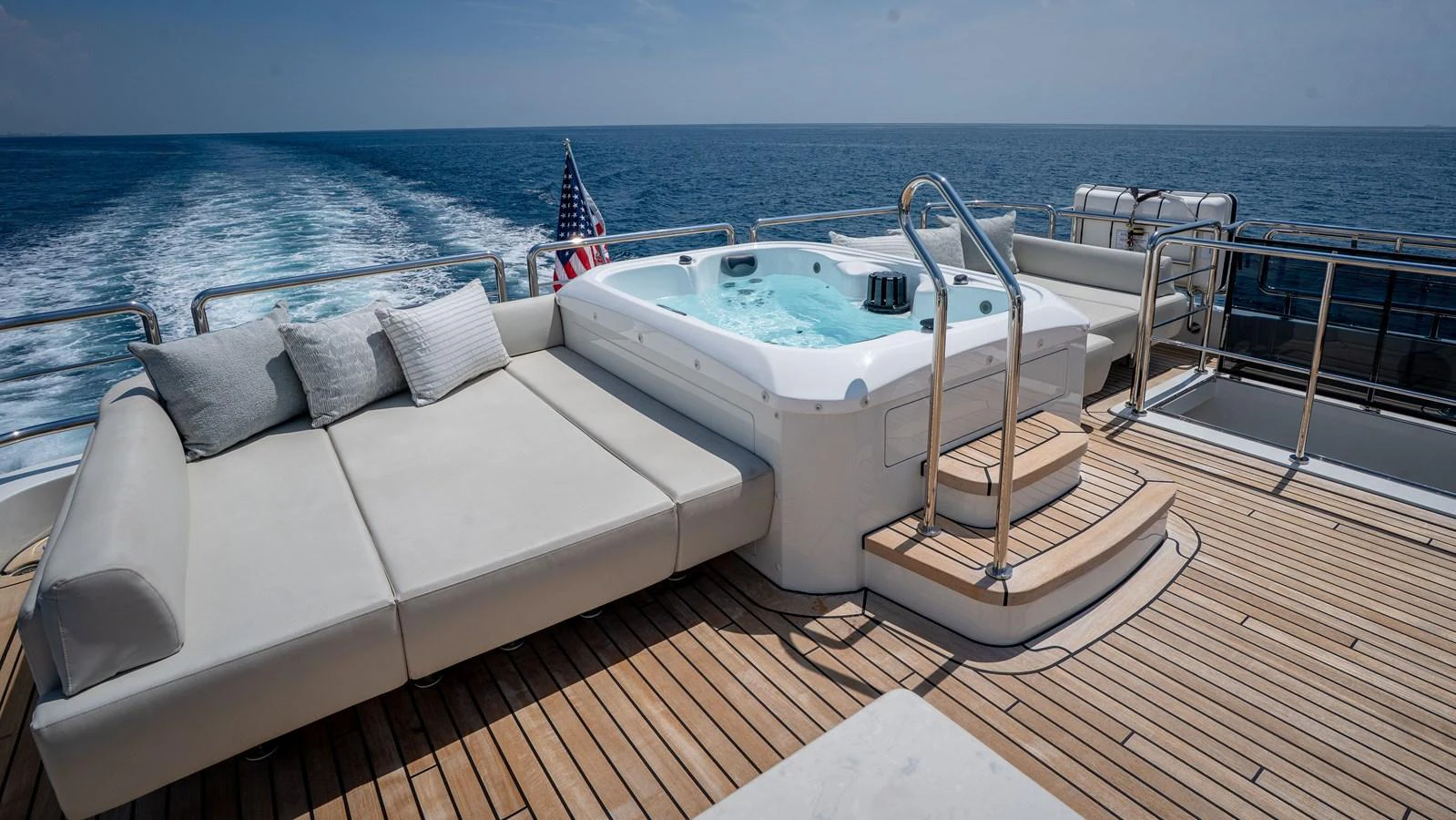 The sundeck features a luxurious hot tub and comfortable lounging area with stunning ocean views. aboard COOL CHANGE Yacht for Sale