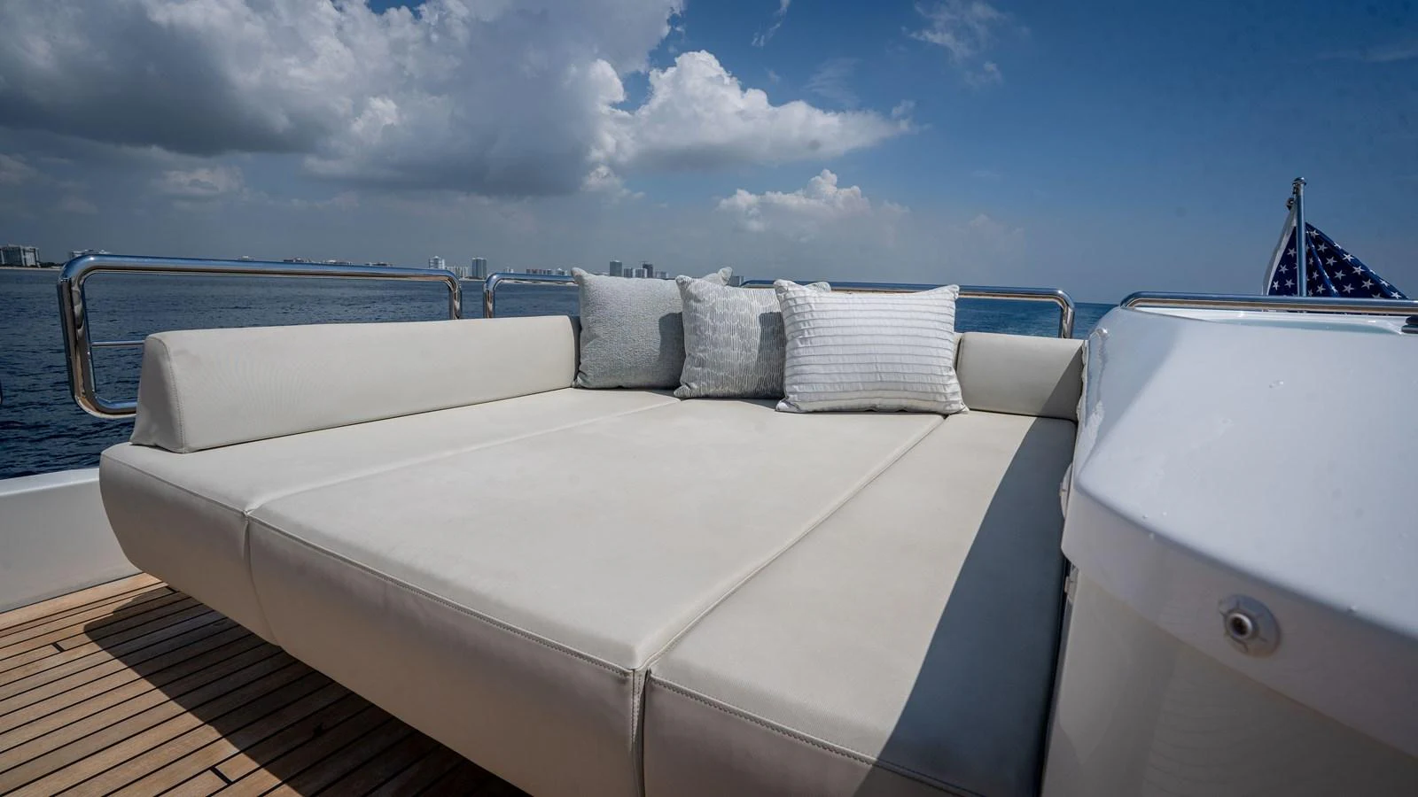 The sundeck features a spacious lounging area with plush cushions, perfect for relaxation under the open sky. aboard COOL CHANGE Yacht for Sale