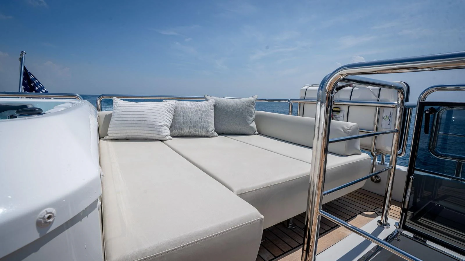 The sundeck features a luxurious lounging area with plush cushions and a serene ocean view. aboard COOL CHANGE Yacht for Sale