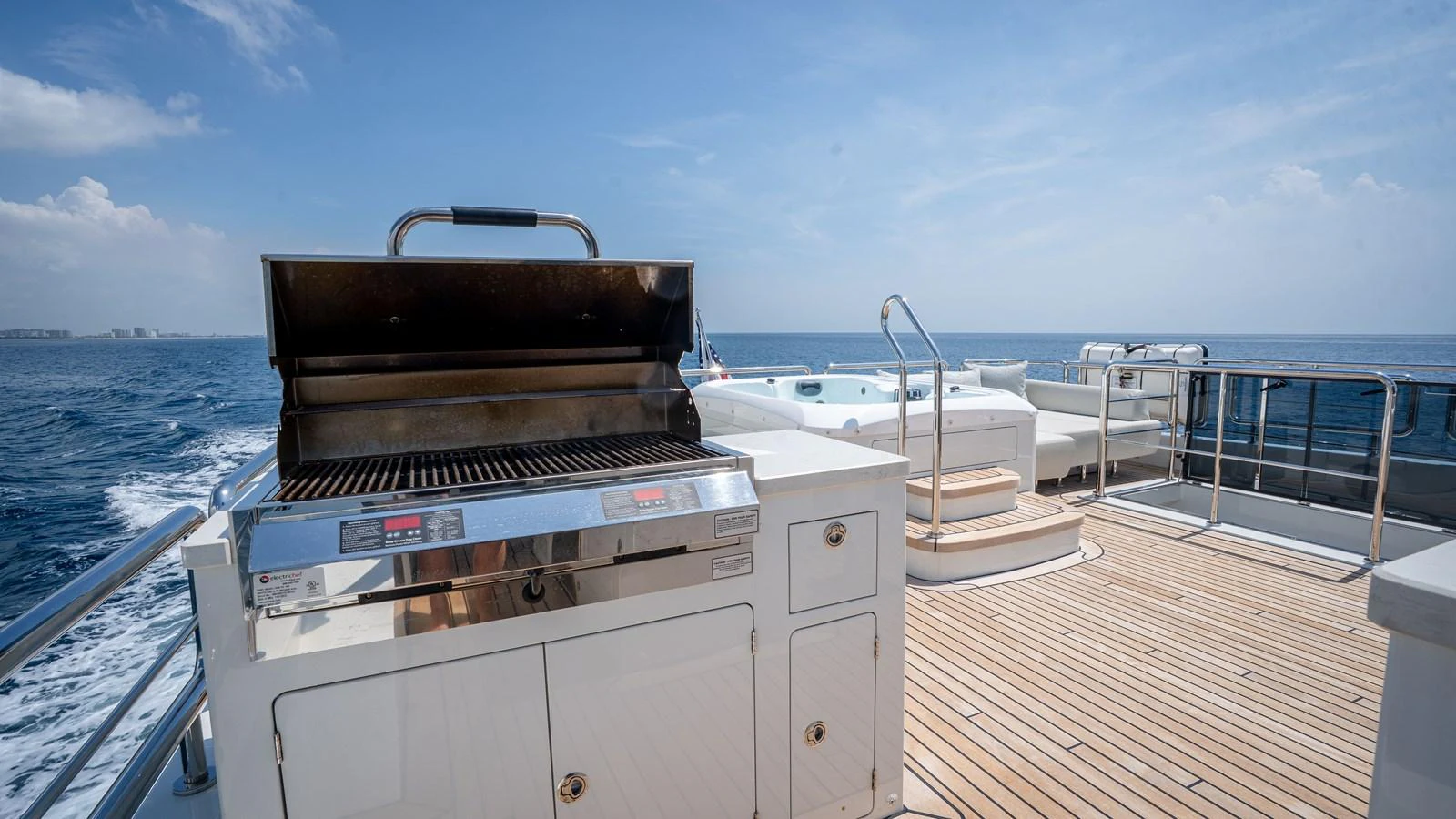 The sundeck features a barbecue grill and a jacuzzi, offering a perfect spot for relaxation and entertainment. aboard COOL CHANGE Yacht for Sale