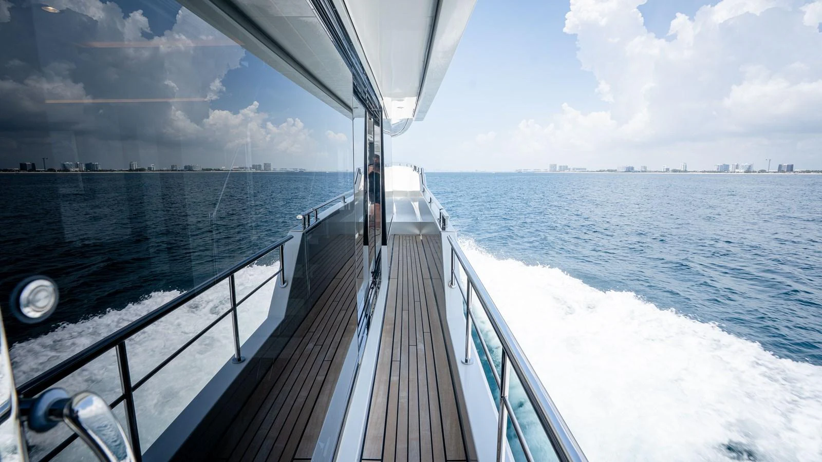 The yacht glides smoothly over the water, showcasing its sleek side deck and expansive ocean views. aboard COOL CHANGE Yacht for Sale