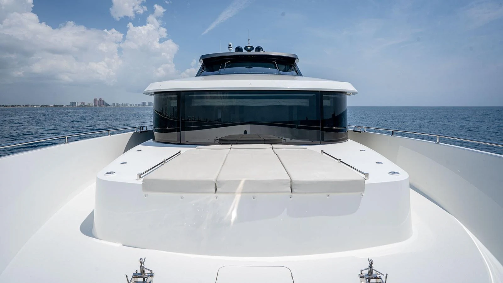 The yacht's foredeck features a spacious sunbathing area with plush cushions, offering a serene spot to relax while cruising. aboard COOL CHANGE Yacht for Sale