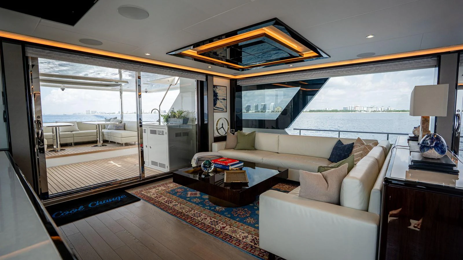 The yacht's salon features a spacious and elegant seating area with large windows offering stunning views. aboard COOL CHANGE Yacht for Sale