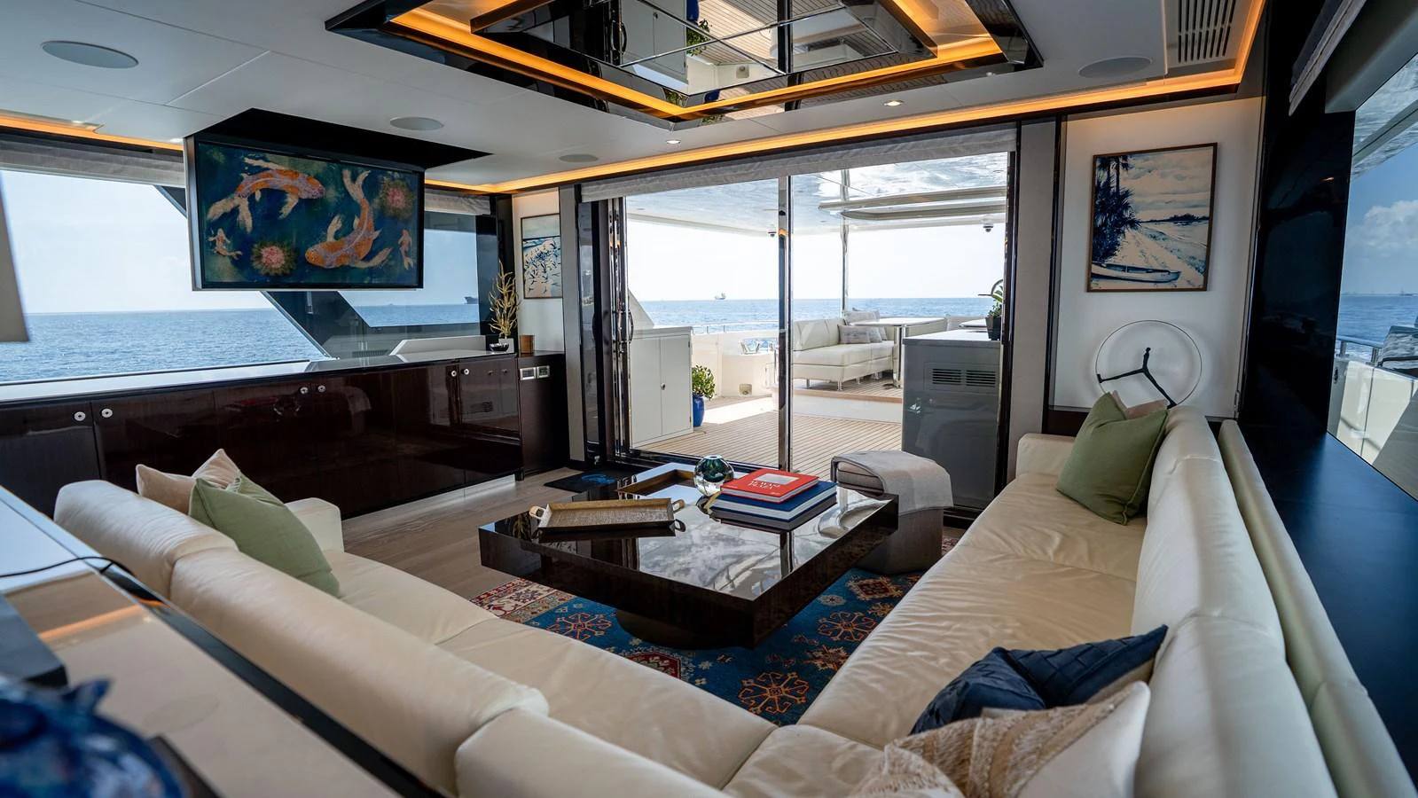 The yacht's salon offers a luxurious and spacious area with comfortable seating and elegant decor, opening up to the aft deck with stunning ocean views. aboard COOL CHANGE Yacht for Sale