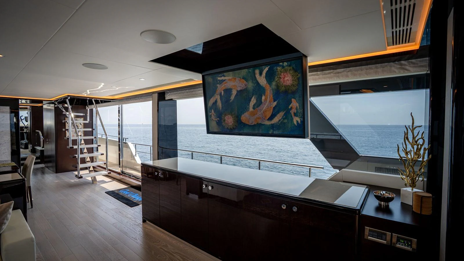 The yacht's interior features a spacious and elegant living area with large windows offering stunning ocean views. aboard COOL CHANGE Yacht for Sale