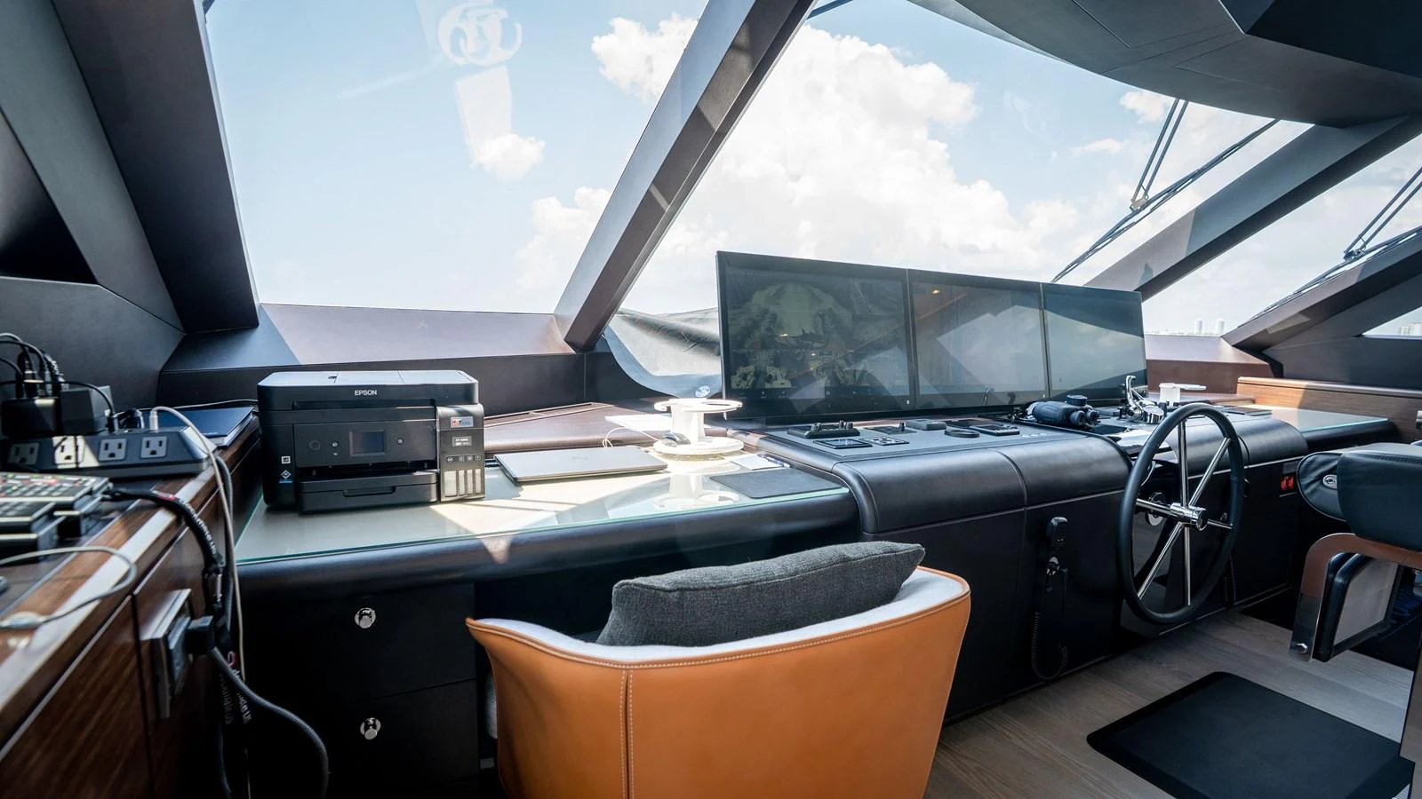 The helm station features advanced navigation equipment and luxurious seating, offering a commanding view for the captain. aboard COOL CHANGE Yacht for Sale