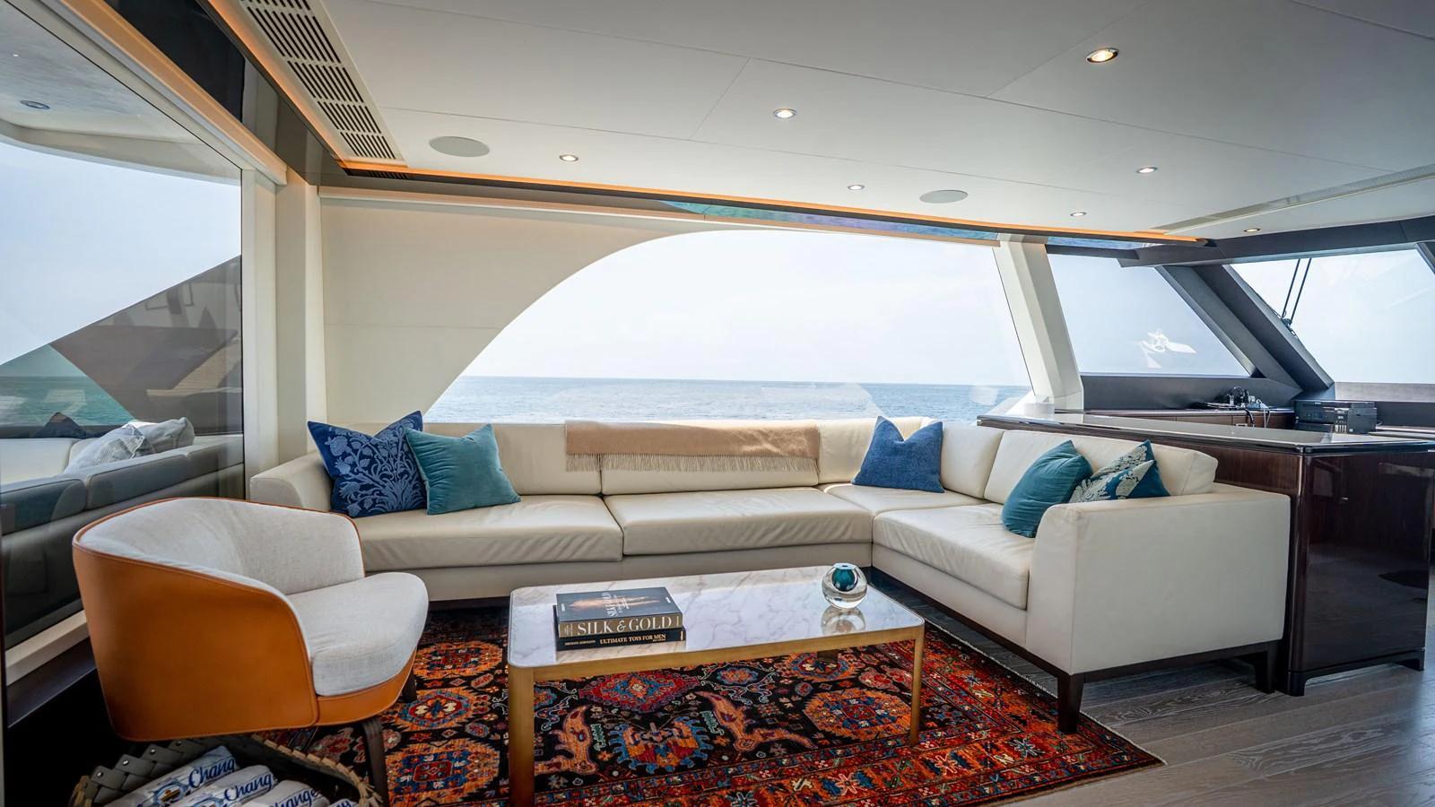 The salon offers a luxurious and comfortable seating area with panoramic ocean views. aboard COOL CHANGE Yacht for Sale