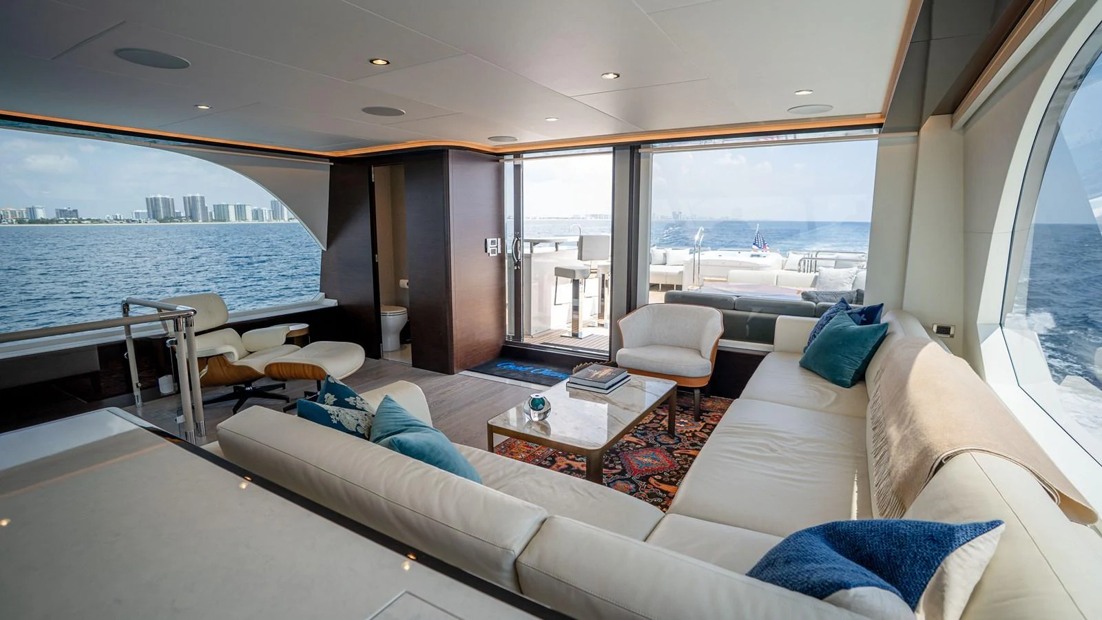 The salon offers a spacious and luxurious seating area with panoramic ocean views. aboard COOL CHANGE Yacht for Sale