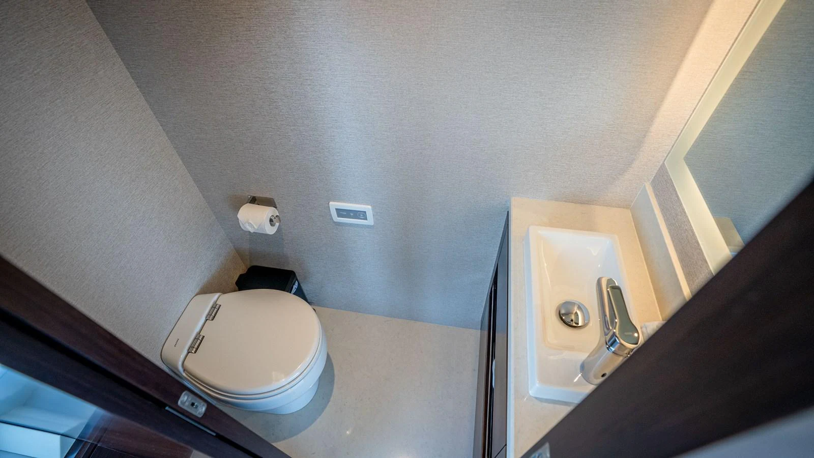 A compact and modern yacht bathroom featuring a sleek sink and toilet. aboard COOL CHANGE Yacht for Sale