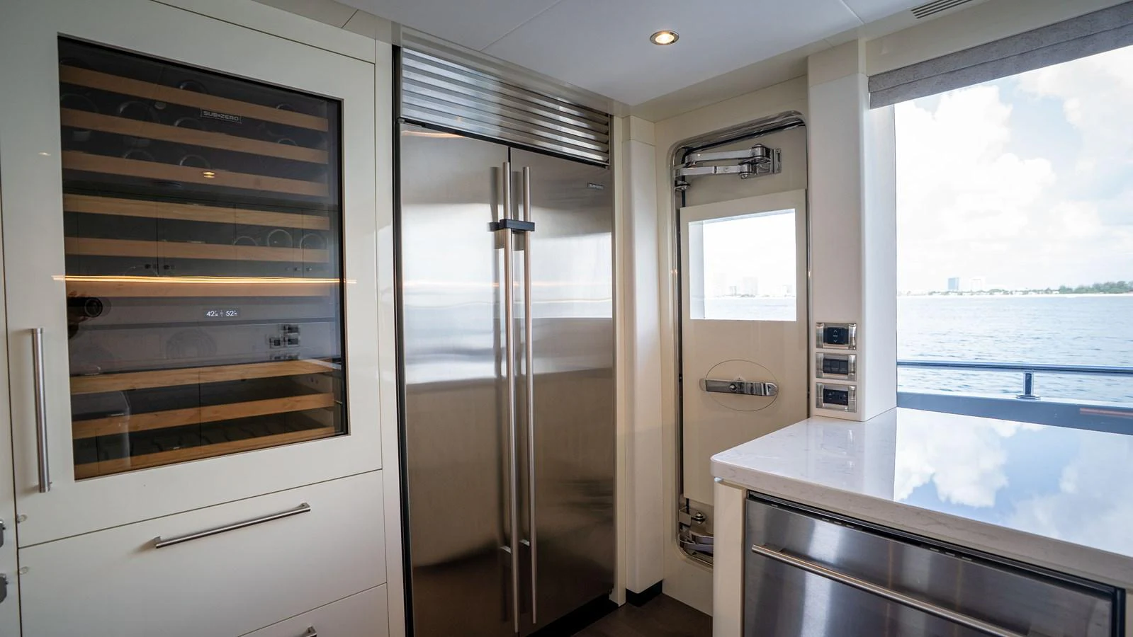 The yacht's galley features modern appliances and a sleek design with a view of the water. aboard COOL CHANGE Yacht for Sale