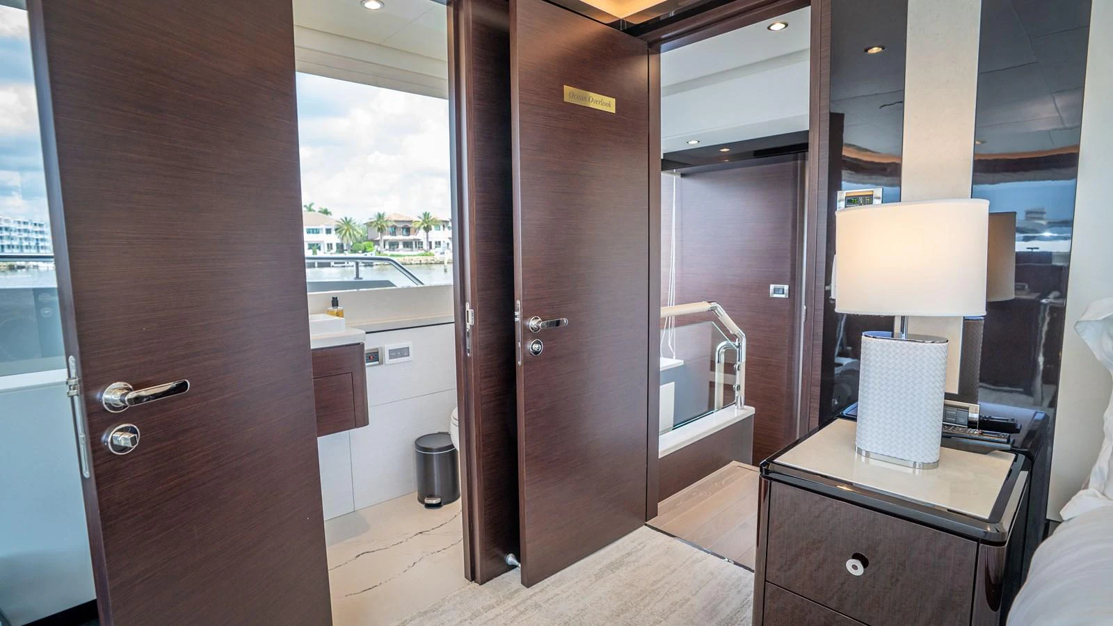 The image showcases a luxurious interior space with modern wooden doors and elegant furnishings. aboard COOL CHANGE Yacht for Sale