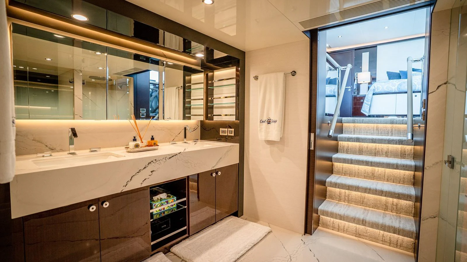 The yacht's bathroom features a luxurious double vanity and modern fixtures, leading up to a cozy stateroom. aboard COOL CHANGE Yacht for Sale