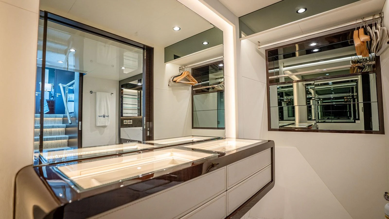 A sleek and modern dressing area with ample storage and mirrors. aboard COOL CHANGE Yacht for Sale