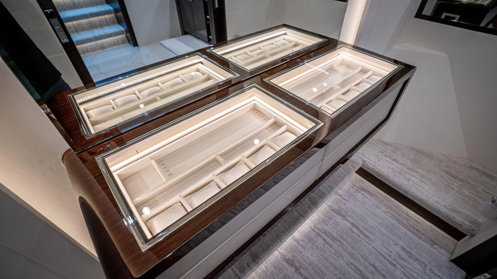 A luxurious display case with elegant wood and glass detailing, perfect for showcasing fine jewelry or accessories. aboard COOL CHANGE Yacht for Sale
