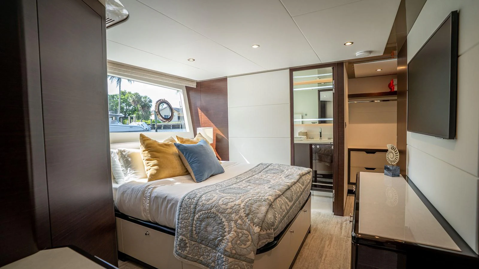 The stateroom offers a cozy and inviting space with a large bed, ample natural light, and modern furnishings. aboard COOL CHANGE Yacht for Sale