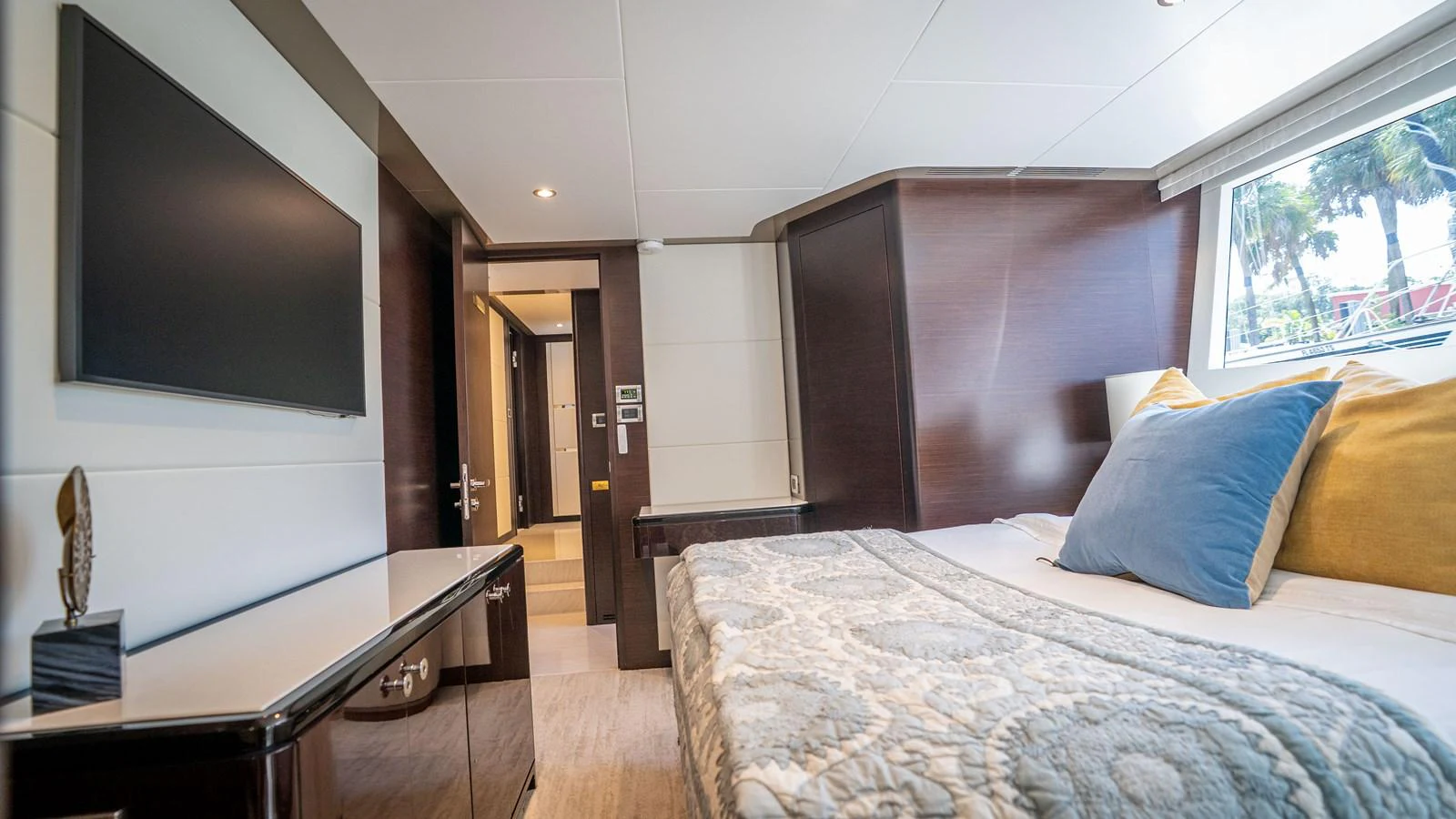 The stateroom features a comfortable bed with plush pillows and a modern flat-screen TV. aboard COOL CHANGE Yacht for Sale