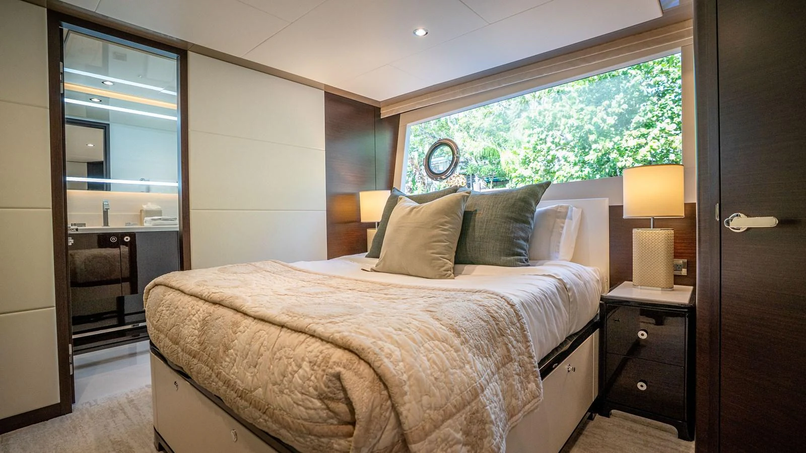 A luxurious stateroom featuring a comfortable bed, large window, and elegant decor. aboard COOL CHANGE Yacht for Sale