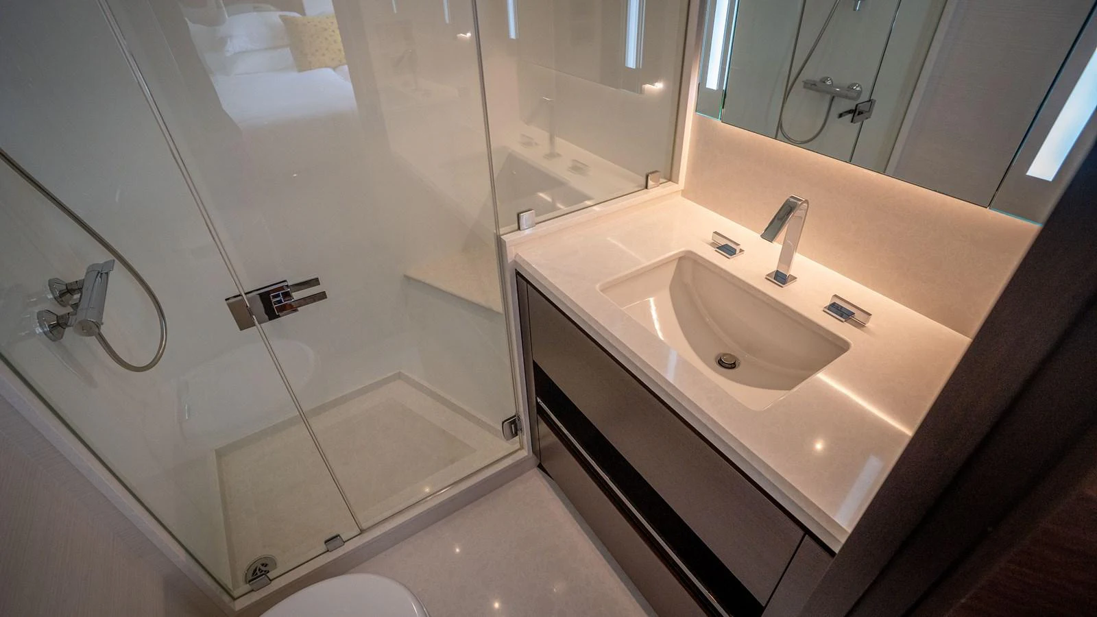 The yacht's bathroom features a sleek and modern design with a spacious shower and elegant sink area. aboard COOL CHANGE Yacht for Sale