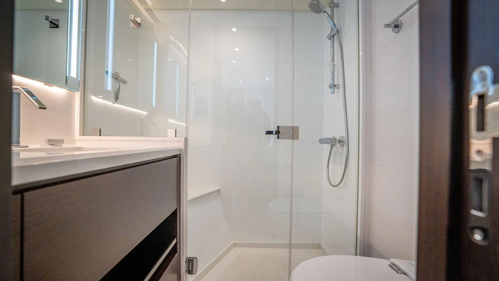 A sleek and modern bathroom with a glass-enclosed shower and contemporary fixtures. aboard COOL CHANGE Yacht for Sale