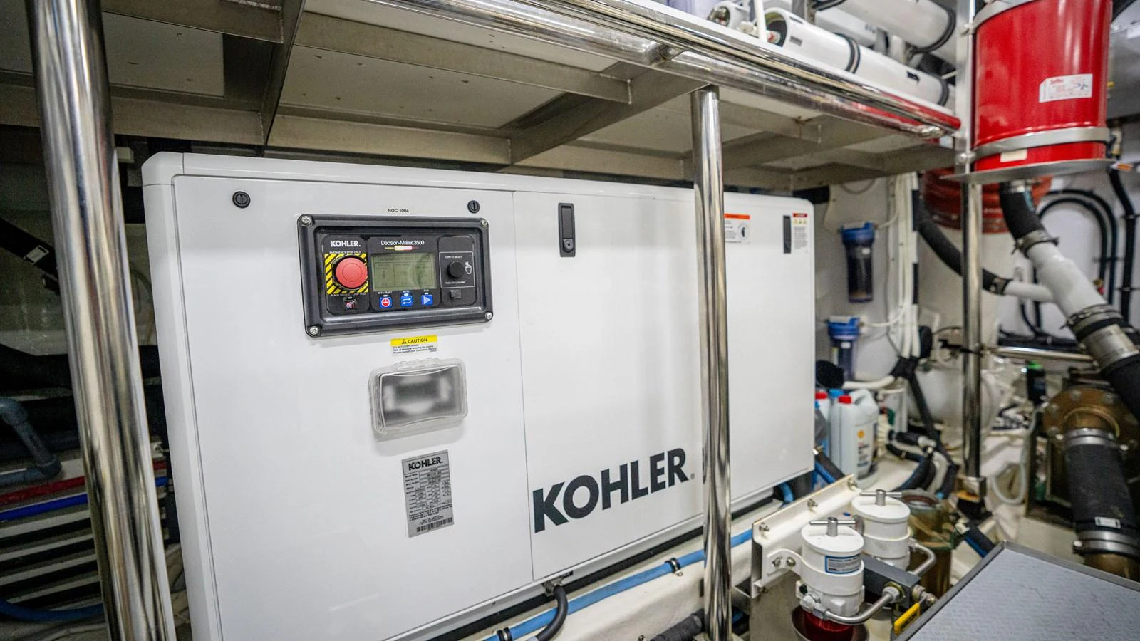 The image showcases the yacht's engine room with a Kohler generator and various mechanical components. aboard COOL CHANGE Yacht for Sale
