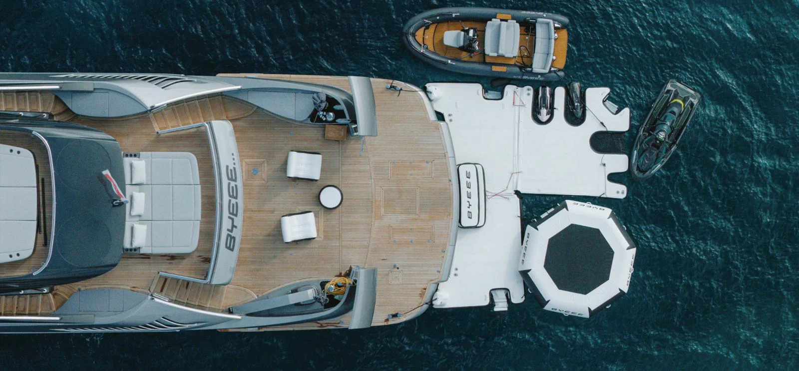 The aft deck of the yacht features a spacious layout with multiple tenders and water toys ready for adventure. aboard BYEEE... Yacht for Sale