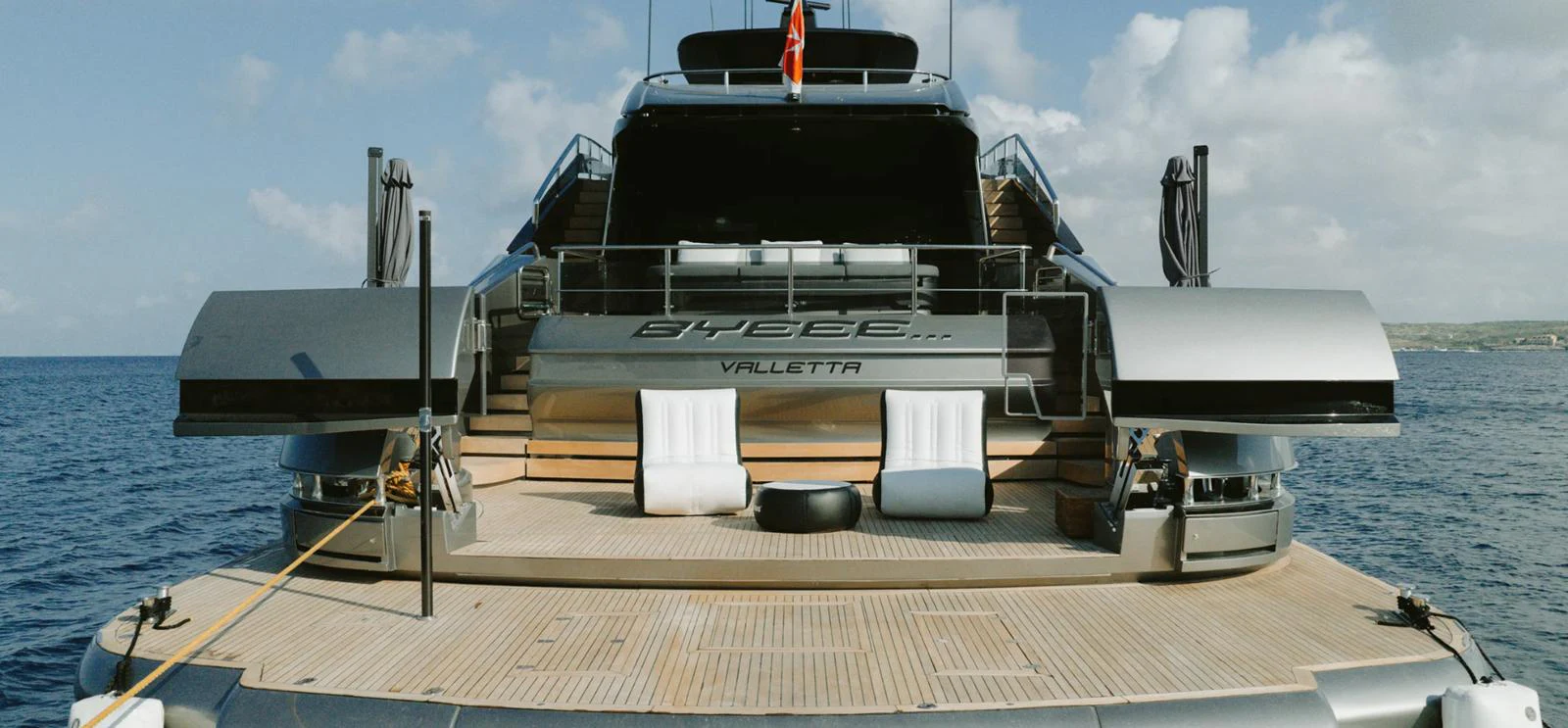 The yacht's aft deck features a spacious lounging area with modern seating and a sleek design. aboard BYEEE... Yacht for Sale