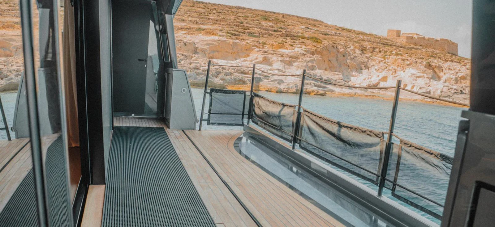 The side deck offers a serene view of the surrounding landscape and water. aboard BYEEE... Yacht for Sale