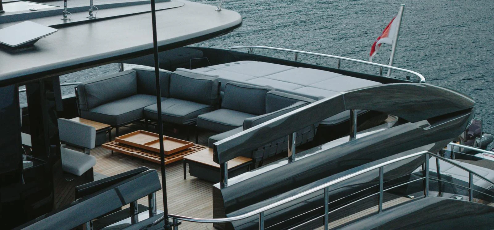 The yacht's aft deck features a luxurious seating area with modern furnishings and a sleek design. aboard BYEEE... Yacht for Sale