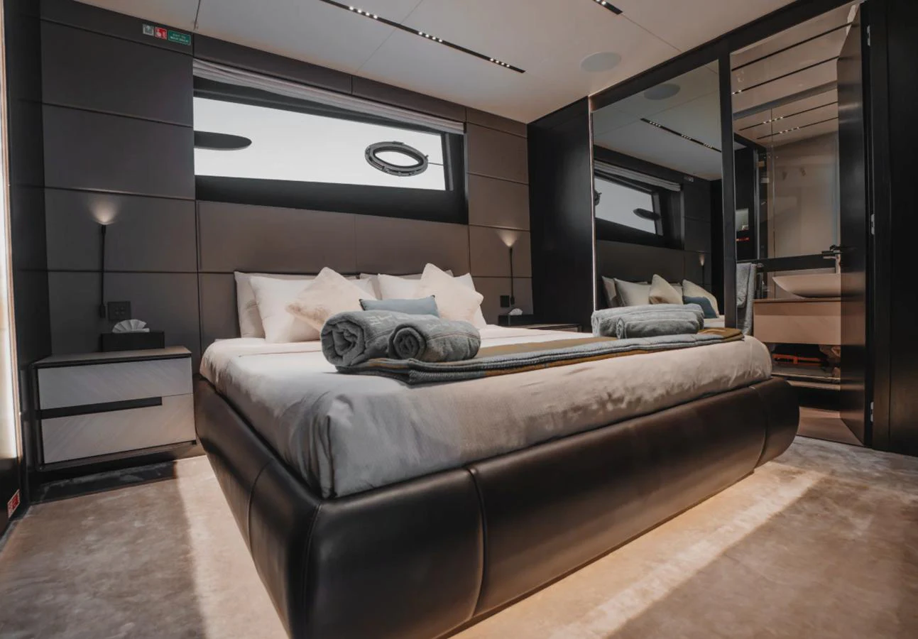 A luxurious stateroom featuring a large bed with plush bedding and modern decor. aboard BYEEE... Yacht for Sale