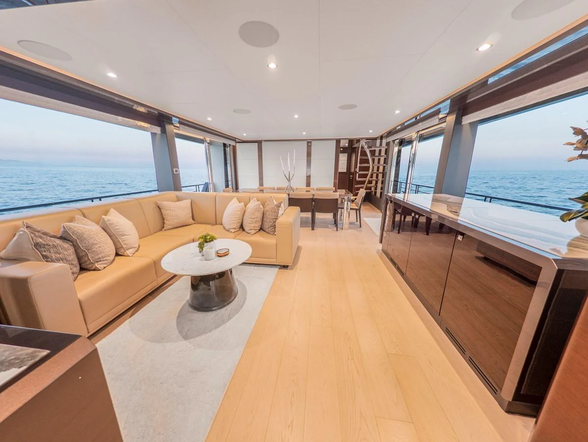 The salon offers a spacious and elegant seating area with panoramic ocean views. aboard LONE STAR Yacht for Sale