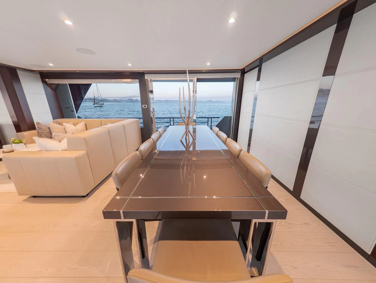 The yacht's dining area offers a luxurious setting with a stunning view of the sea. aboard LONE STAR Yacht for Sale