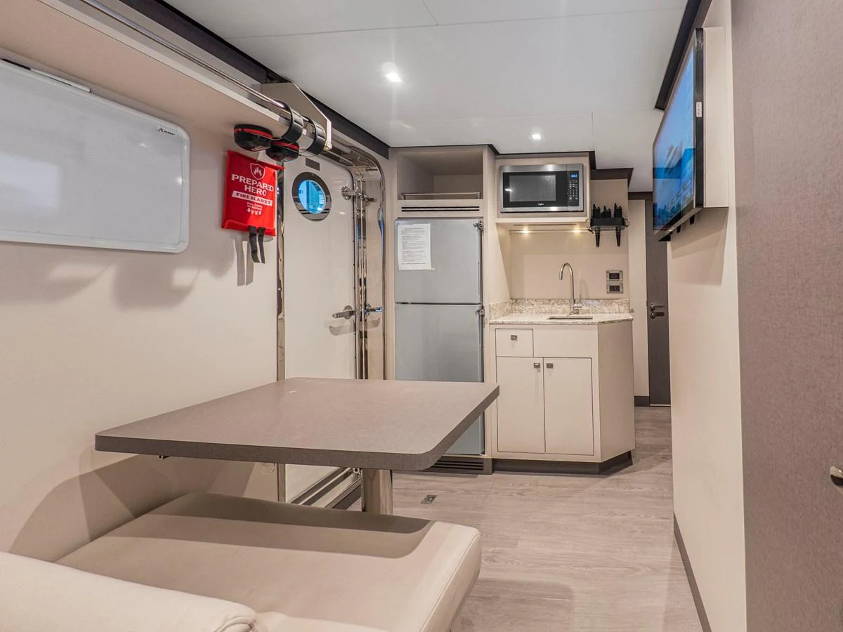 The yacht's galley features modern appliances and a cozy dining area. aboard LONE STAR Yacht for Sale