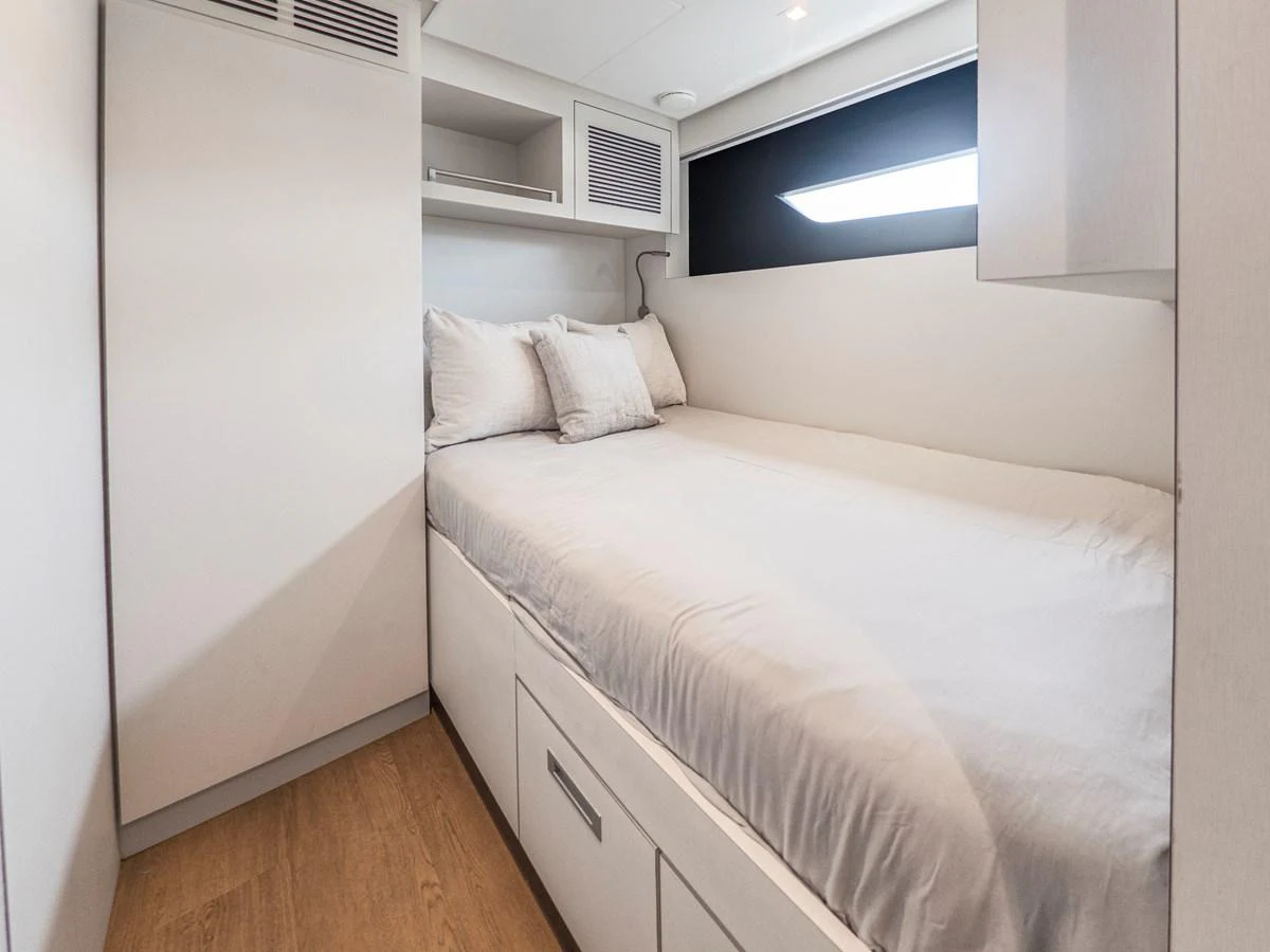 The guest cabin features a cozy bed with soft linens and ample storage space. aboard LONE STAR Yacht for Sale