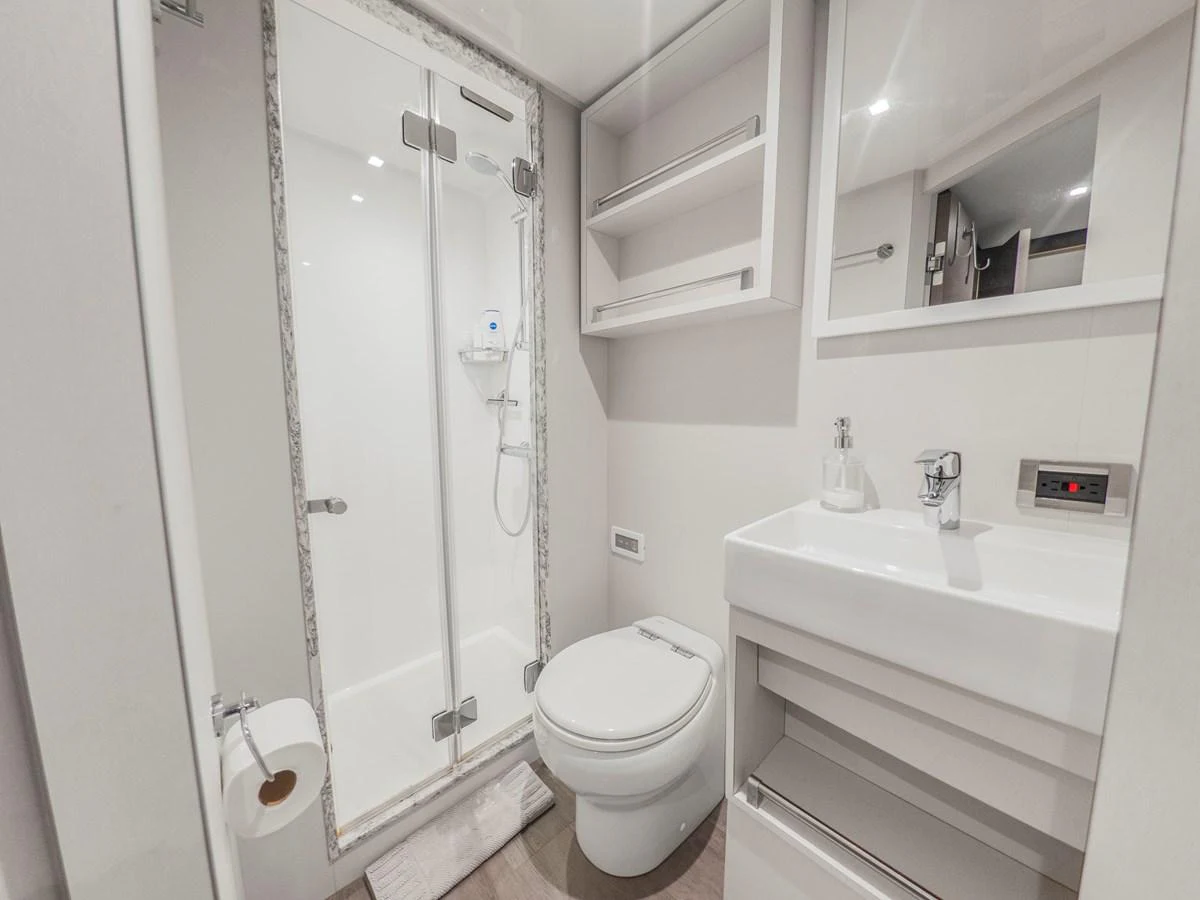 The yacht's bathroom features a modern shower enclosure and sleek fixtures. aboard LONE STAR Yacht for Sale